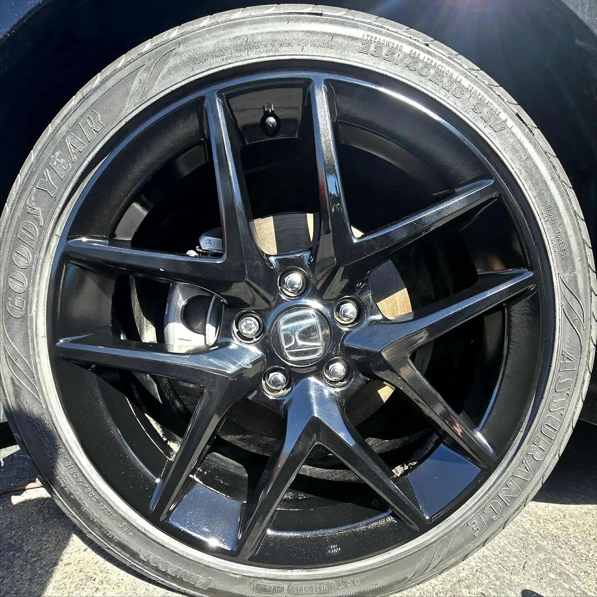 Black alloy Honda wheel after lip rash repair