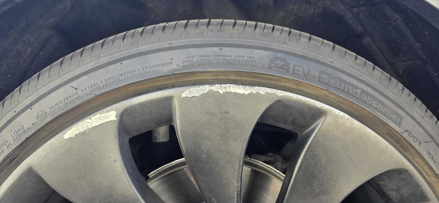 Tesla wheel before curb rash repair, Las Vegas